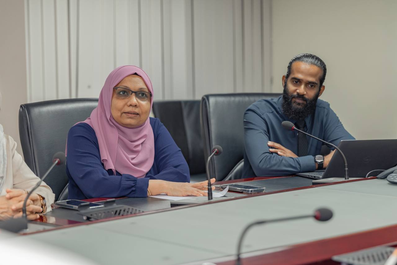 Two jurors of the Maldives Financial Sector Awards reviewing submissions during a panel session